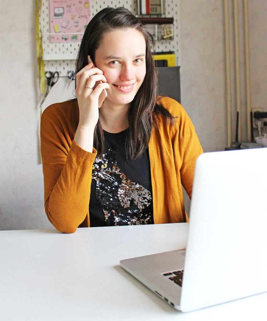 Anouk aan telefoon achter laptop